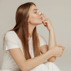 A young woman with a bandage on her nose after rhinoplasty