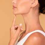 Side view of unrecognizable young woman touching her face, chin augmentation concept