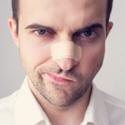 Unhappy male patient with his rhinoplasty results